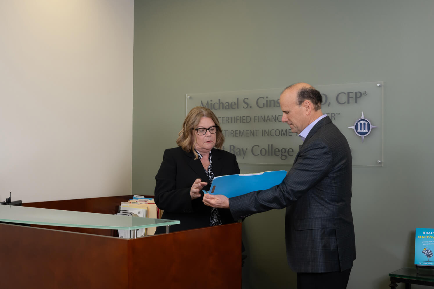 Michael & Kelly standing in front of a desk