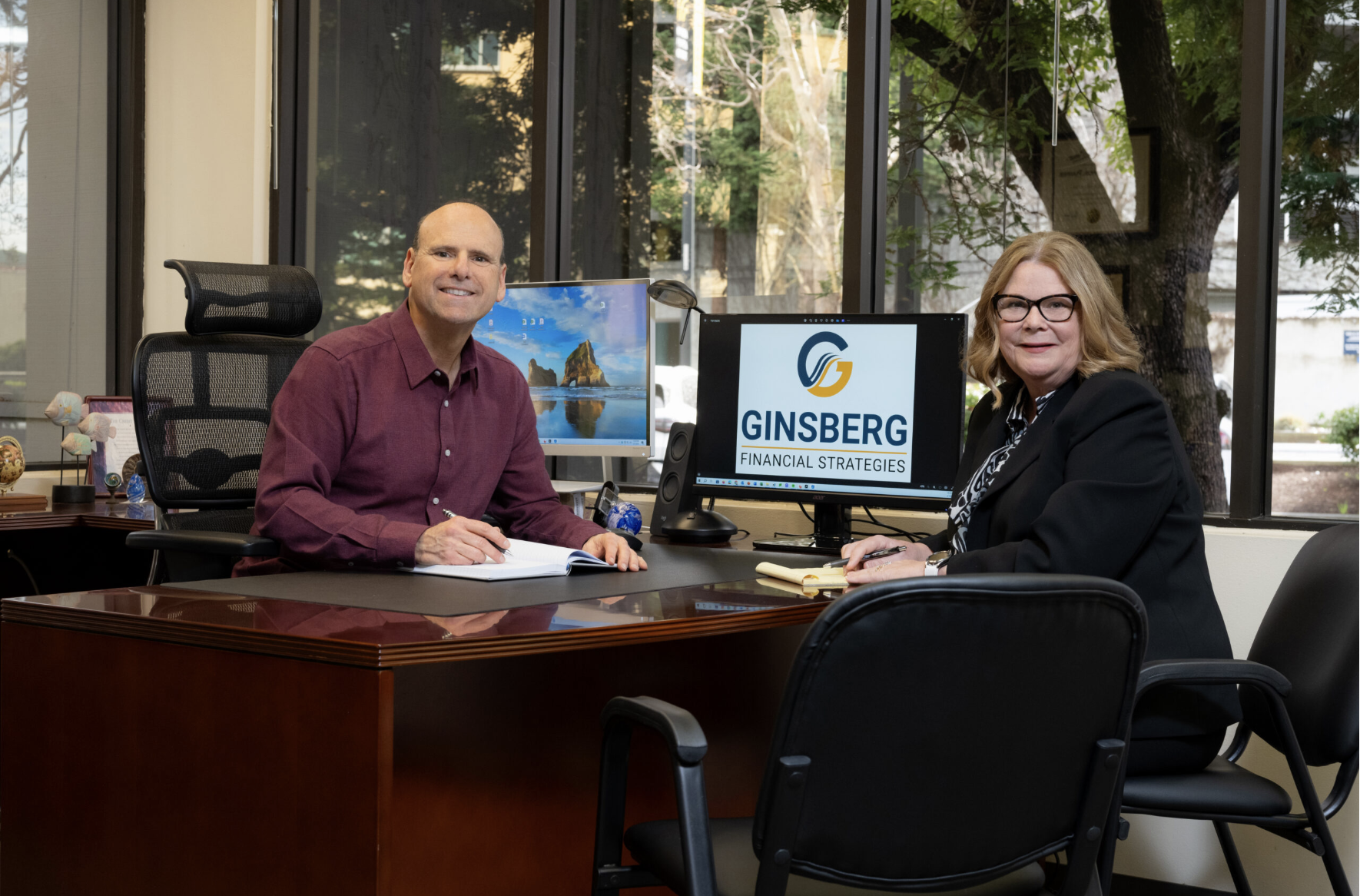 Michael discussing financial planning with Kelly at Ginsberg Financial Strategies office Michael discussing financial planning with Kelly at Ginsberg Financial Strategies office