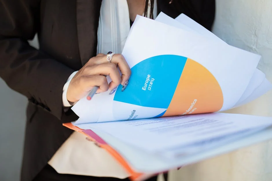 Professional reviewing a financial report with a pie chart and investment analysis documents.