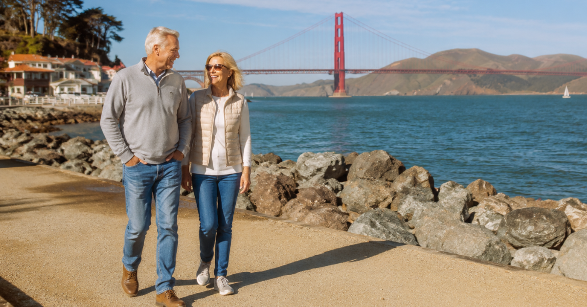 user-inserted An older couple strolls along the waterfront, with the Golden Gate Bridge majestically visible in the background.